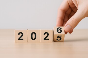 Wooden Blocks Displaying Year 2026 with Hand, Forecasting New Year Goals and Future Predictions