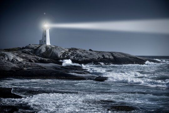 Peggy’s Cove lighthouse beam over rough ocean waters in Nova Scotia