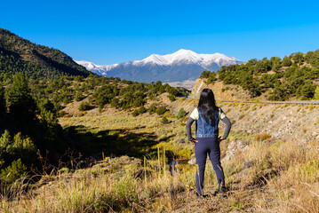 a traveler stands before Mount Princeton, where blue skies stretch endlessly over Colorado’s autumn roads.