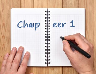 Hands Writing In Open Spiral Notebook On Wooden Table