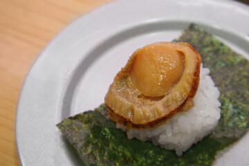 Japanese Hotate Nigiri Sushi with Seaweed on White Plate, Seared Scallop over Sushi Rice, Traditional Japanese Dish
