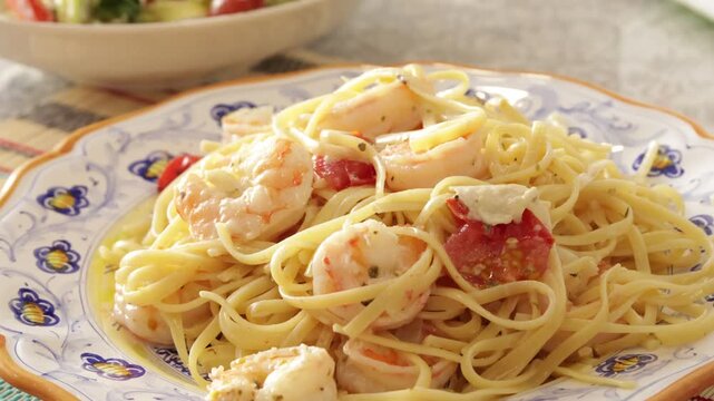 Homemade durum wheat spaghetti with seafood on ceramic plate with ornament. Organic food and healthy eating.
