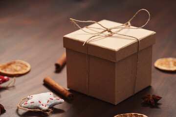 Christmas gift box from eco friendly paper wrapped with natural twine on wood table with natural decorations