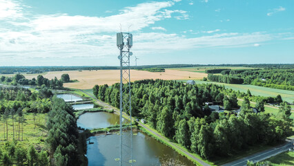 Cell tower overlooking green countryside fields
