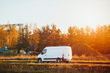 White delivery van driving on rural road © AlexGo