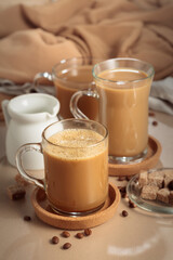 Latte with brown sugar on a beige background.