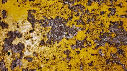Close up of Asphalt with yellow road markings background. black road dividing lines. Empty highway asphalt road. The rough asphalt road surface with peeling paint on the highway.