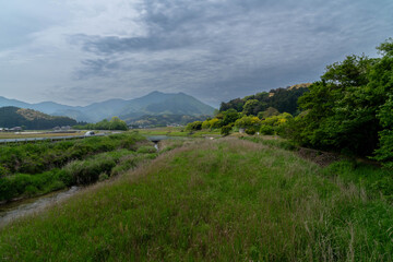A stream flows near a rural village in Fukuoka Prefecture, Japan.