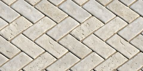 Obraz premium Cream colored stone herringbone pattern, rectangular tiles at diagonal angles, natural limestone texture, classic parquet-style arrangement, elegant design.