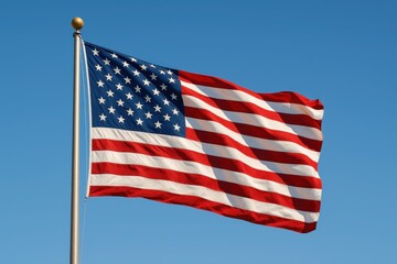 Obraz premium Patriotic American Flag Waving in Bright Blue Sky