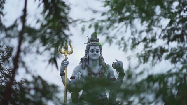 lord shiva statue outdoors, hindu god shiva sculpture, religious shiva idol with trident, divine shiva murti in temple stock video.