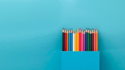 Color Pencils in a Box on Blue Background, Flat Lay, Top View, Artistic Concept.