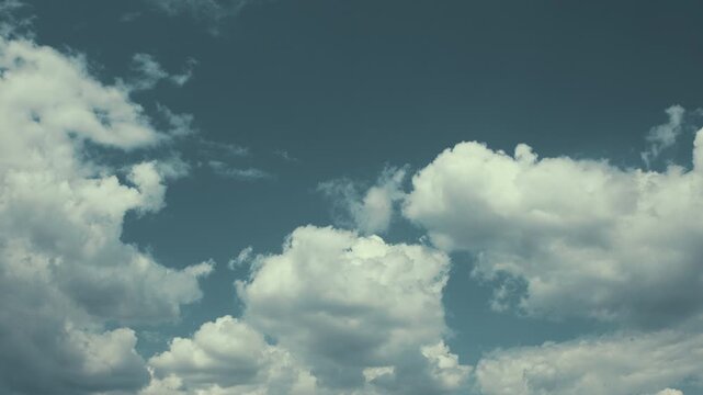 A Serene Cloudy Sky adorned with Soft, Fluffy White Clouds gently floating above
