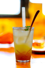 Ice tea with lemon and mint on dark rustic background