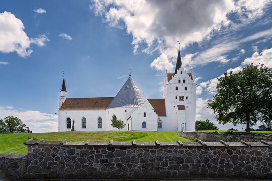 Historic White Horne Church with Tower Under a Vibrant Blue Sky, Faaborg, Denmark
