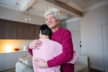 Cheerful happy older husband hugging wife spouse with affection. Peaceful healthy partnership, enduring love in family, emotional security, husband care and stable union, shared life joy together