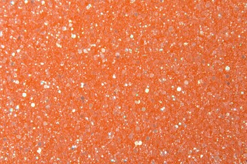 Abstract Orange Glitter Texture Background with Sparkling Particle Close Up View