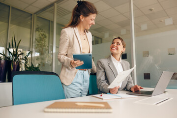 Professional Women Engaging in Collaboration Within a Modern Office Environment Setting
