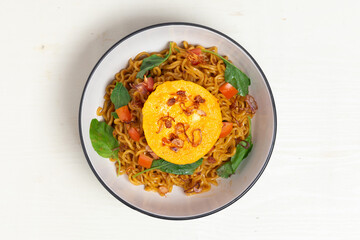 Classic Indonesian instant noodles, Indomie Goreng, with a fried egg. This close-up highlights the rich seasonings and perfectly cooked noodles.