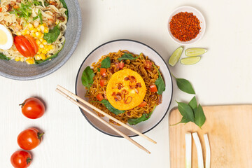 A simple yet satisfying meal of Indomie Goreng with a fried egg. The image emphasizes the rich colors and textures, perfect for food blogs or menus.