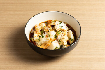 Tahu Kupat is a savory and flavorful Indonesian street food. This photo shows the crispy tofu, soft rice cakes, and fresh bean sprouts.