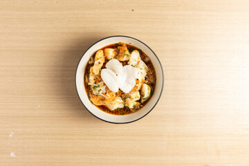 Tahu Kupat is a savory and flavorful Indonesian street food. This photo shows the crispy tofu, soft rice cakes, and fresh bean sprouts.