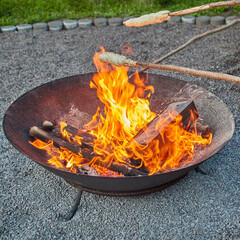 Stick bread or stick cake over a burning fire bowl