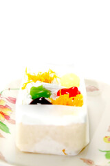 Gourmet dessert closeup with a fresh fruit cake topped with sweet strawberries and raspberries