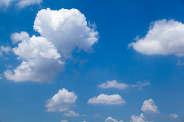 Beautiful blue sky with fluffy white clouds, perfect for backgrounds, nature landscapes, and creative design projects