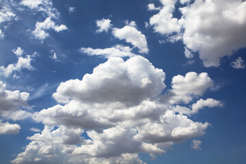 Wide blue sky with fluffy clouds, evoking freshness, warmth, and hope. Perfect for designs about freedom, inspiration, and nature