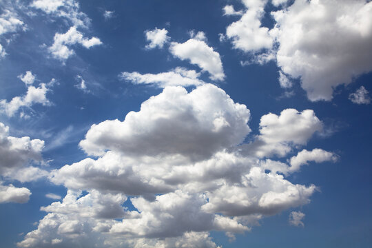 Wide blue sky with fluffy clouds, evoking freshness, warmth, and hope. Perfect for designs about freedom, inspiration, and nature