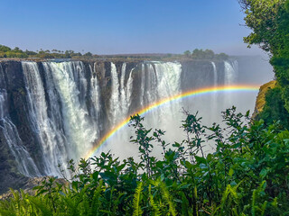 Victoria Falls in Zimbabwe with little water, rainbow.