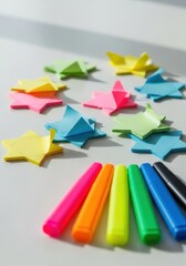 Fototapeta premium Artistic still life composition of colorful paper stars and vivid markers