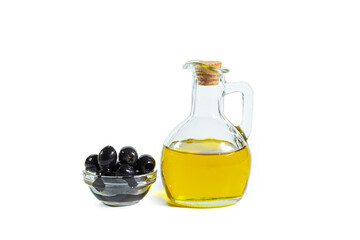 Extra virgin olive oil in a transparent jug and black olives in a bowl.