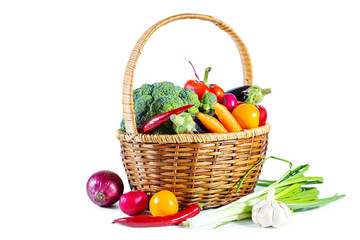 Fresh shiny multi-colored vegetables in a wicker basket.
