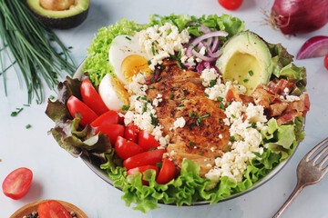 A bowl with cobb salad, traditional American dish