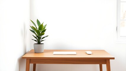 Modern wooden desk corner with a potted plant, natural light and clean workspace aesthetic.