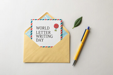 World Letter Writing Day Greeting Card in Envelope with Pen and Leaf on White Background