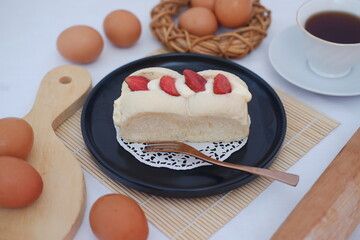 Strawberry Cream Bread on Black Plate with Eggs and Tea