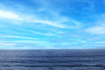 Ocean Horizon under a Blue Sky with Wispy Clouds