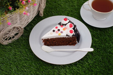 Delicious Slice of Cake on a Plate with Tea