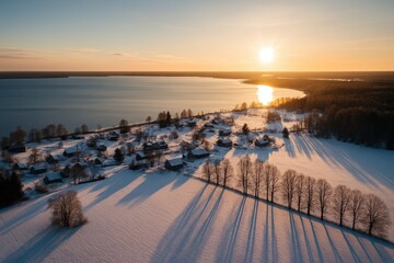 Obraz premium Drone captured scenic winter landscape featuring a tranquil lake and tree shadows on the snow.