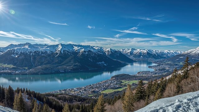 Snow sports location featuring panoramic mountain scenery and a glacial lake in the cold season
