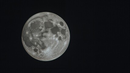 Visible craters with a prominent full moon, including a central large crater and a notable crater in the lower right area.