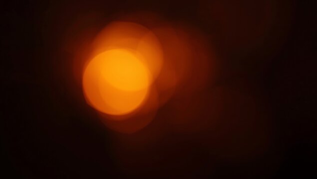 grainy colorful warm orange light leaks on black background with dust texture. abstract damaged scratched retro film analog effect for using over photos as overlay or screen filter