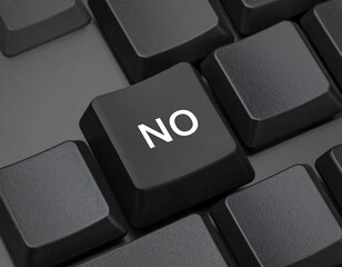 Black computer keyboard with a single highlighted key displaying the word NO in white text