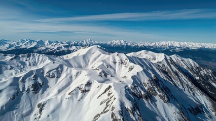 Fototapeta premium Overhead Drone Perspective of Snow-Laden Mountain Range