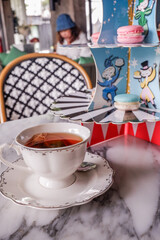 Afternoon tea and dessert,Cup of tea with macaroons,Bakery set in stainless stand,high tea with dessert, pastry, scones,Sweet Treats.