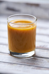 Mango smoothie on bright background. Soft focus. Copy space.	