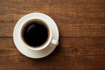 A cup of black coffee placed on a wooden tabletop